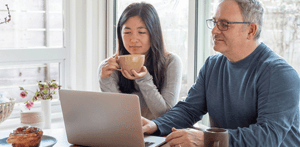 man and woman looking at a laptop