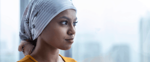 woman wearing a headscarf looking out