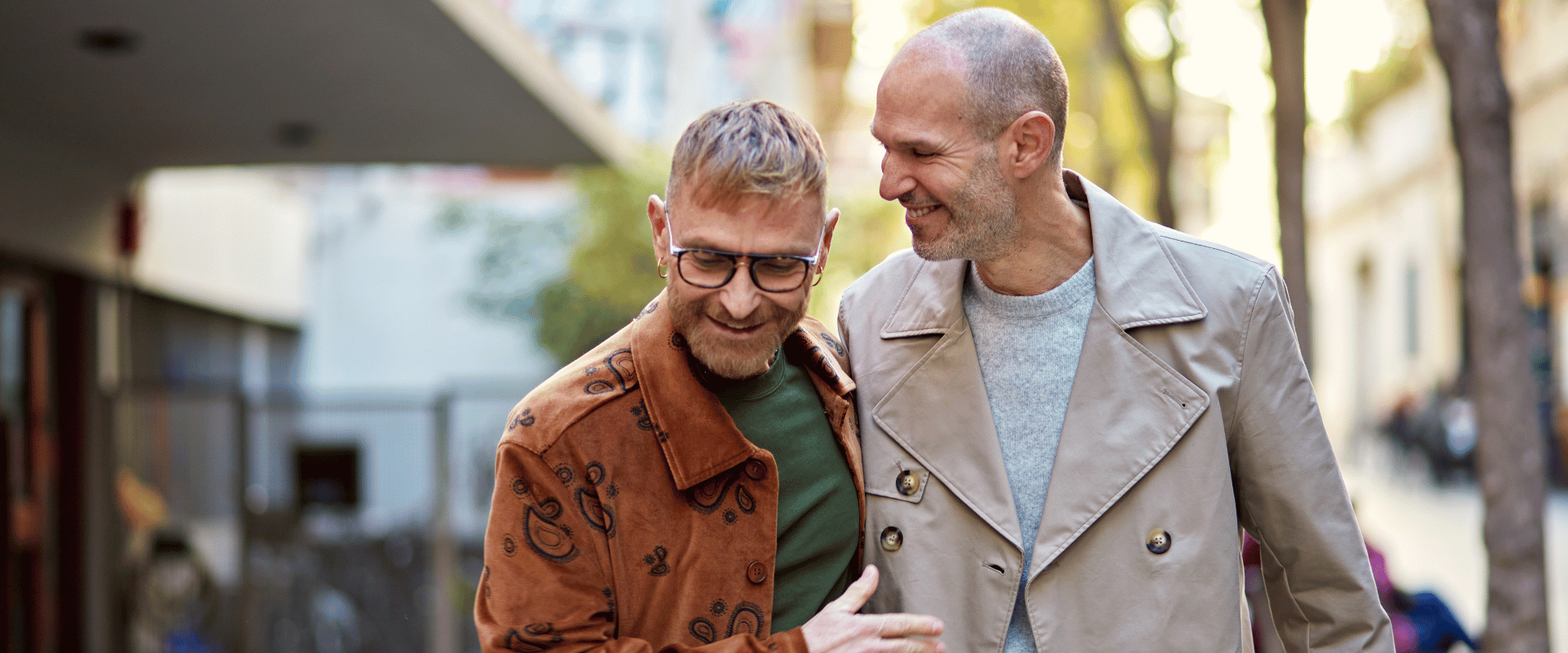 two male partners walking together and smiling