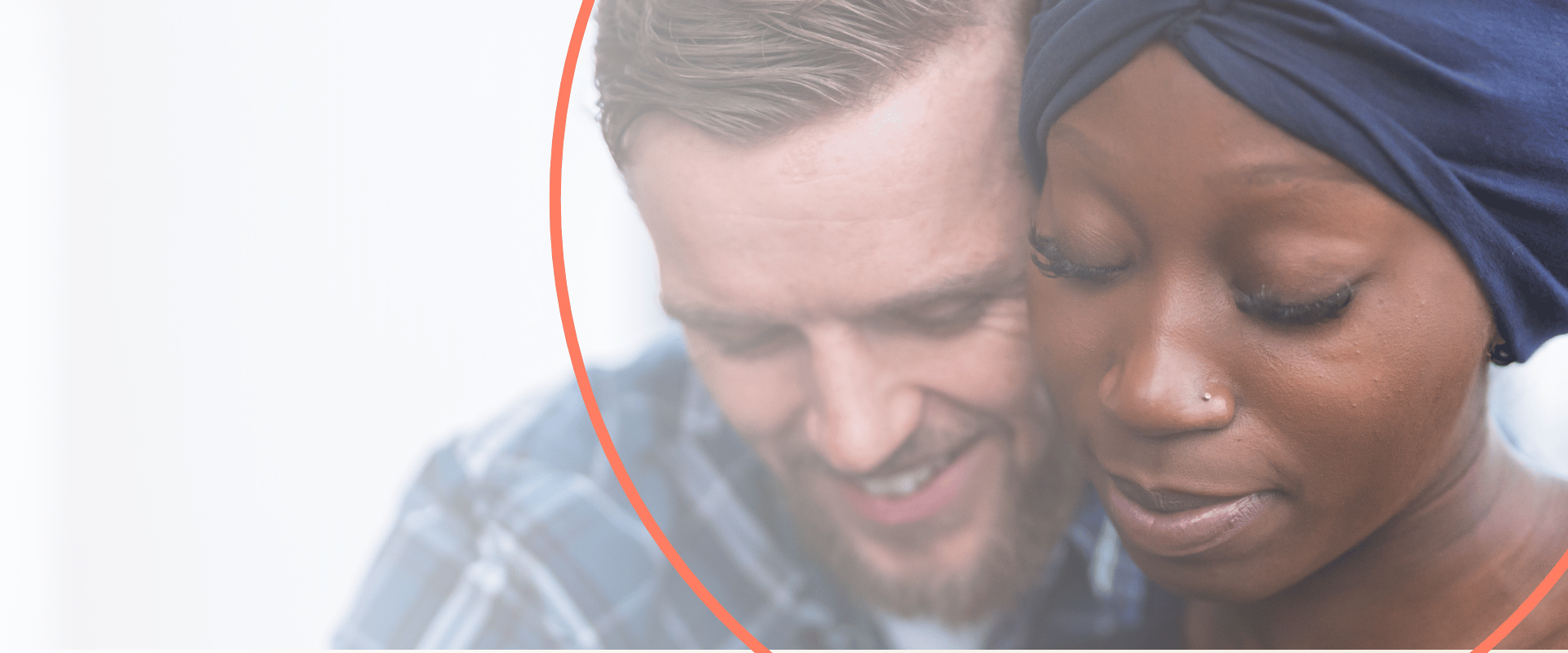woman with cancer next to smiling male partner on white background with orange circle around them