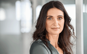 Portrait of a woman with dark hair in an office