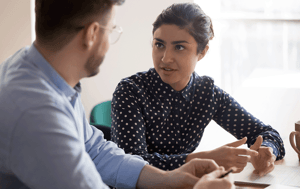 man and woman having a conversation at work