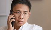 Asian man on mobile phone deep in conversation