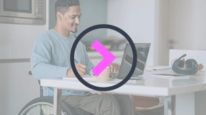 man in a wheelchair working from home on a laptop with a play icon overlayed