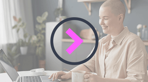 video play button over a background image of a woman recovering from cancer working from home on a laptop