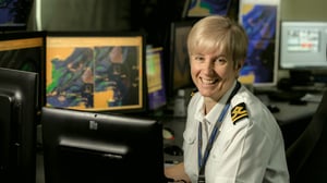Port of london employee siting at desk smiling to camera