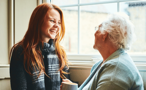young woman carer smiling at grandmother